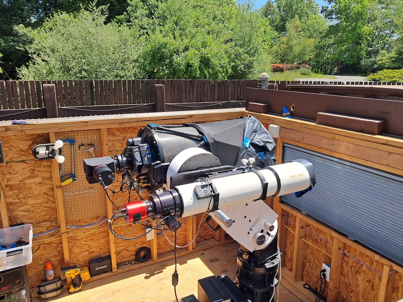 Dual telescope setup with imaging equipment inside observatory structure